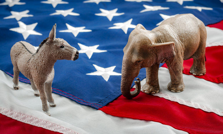 Democrats vs republicans are facing off in a ideological duel on the american flag. In American politics US parties are represented by either the democrat donkey or republican elephant