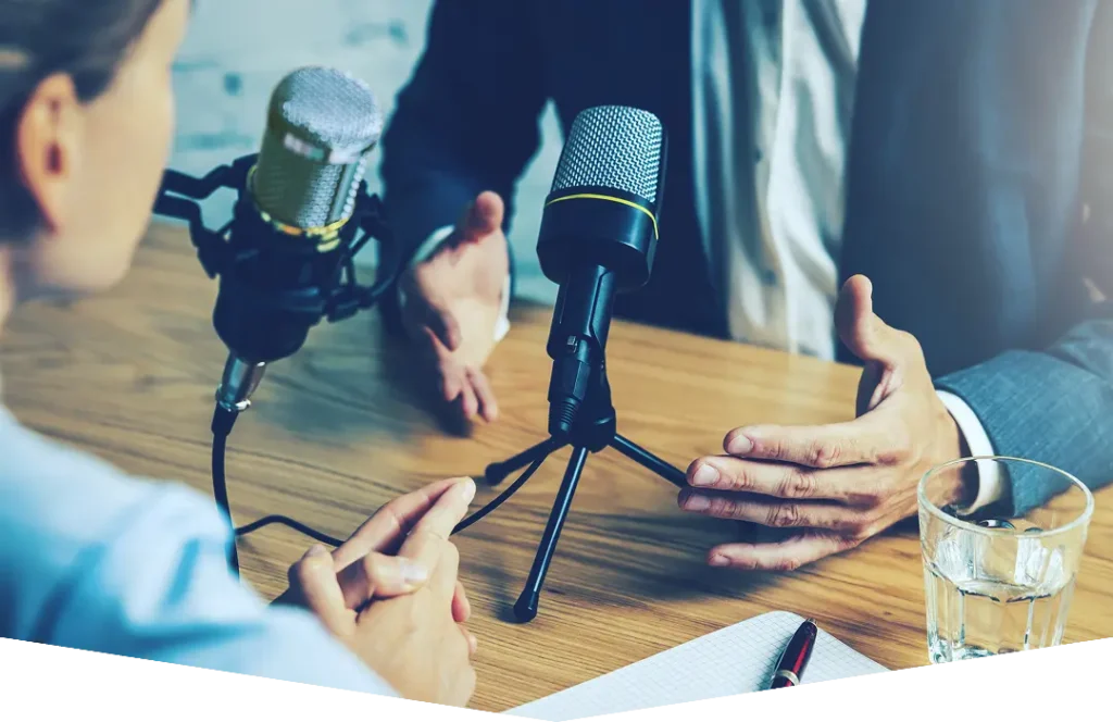 People gathered around desk with microphone